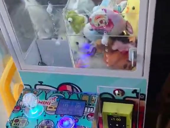DoBetter claw machine full of plush prizes inside Curry Pizza House in Manteca