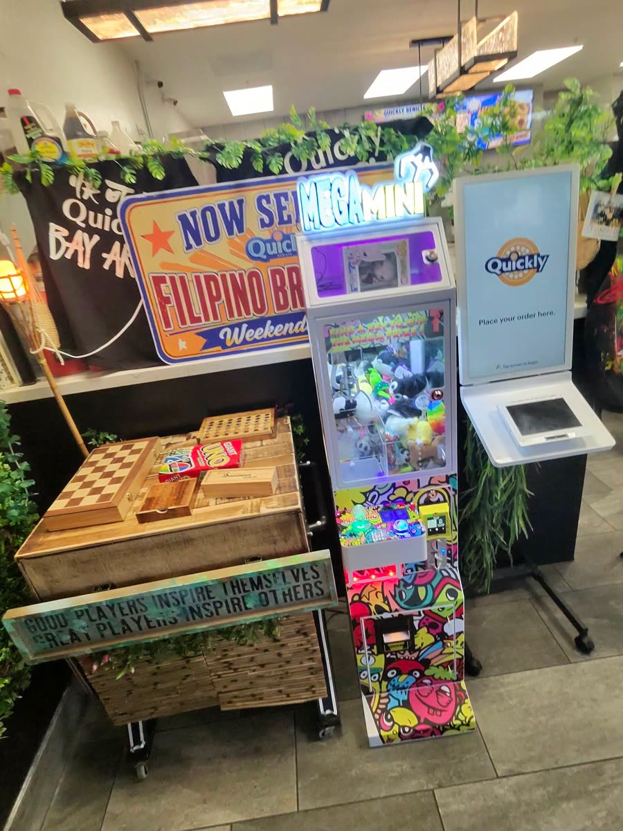 DoBetter Mega Mini claw machine next to the order kiosk at Quickly in Benicia