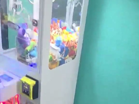 DoBetter claw machine against a teal wall at The Wash Box laundromat in Stockton